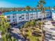 Modern condo complex with lush landscaping and private parking at 8226 Harborside Cir, Englewood, FL 34224