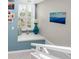 Bright landing with window seat, decorative accents, and access to upper level at 8226 Harborside Cir, Englewood, FL 34224