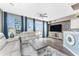 Bright and airy living area with hardwood floors, large TV, and access to balcony at 8226 Harborside Cir, Englewood, FL 34224