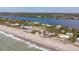 Aerial image of beachfront home near ocean and waterway at 8245 Manasota Key Rd, Englewood, FL 34223