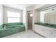 Bathroom featuring a green marble bathtub and vanity at 8245 Manasota Key Rd, Englewood, FL 34223