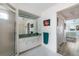 Bathroom with a shower, vanity, and linen closet at 8245 Manasota Key Rd, Englewood, FL 34223