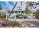 Elevated home with waterfront access, large deck, and a metal roof at 8245 Manasota Key Rd, Englewood, FL 34223