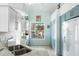 Updated kitchen featuring light blue cabinetry and a double sink at 8245 Manasota Key Rd, Englewood, FL 34223