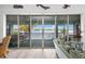 Living room with panoramic water views and sliding glass doors at 8245 Manasota Key Rd, Englewood, FL 34223