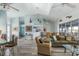 Open-concept living space with high ceilings, water views, and comfortable furniture at 8245 Manasota Key Rd, Englewood, FL 34223