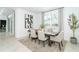 Bright dining room featuring a modern table and chairs, stylish rug, and large window at 8565 Saint Kitts Cir, Englewood, FL 34224