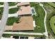 Aerial view of single-Gathering home with tile roof and landscaped yard at 8596 Lakeside Dr, Englewood, FL 34224