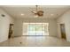 Bright living room with sliding glass doors and view of lake at 8596 Lakeside Dr, Englewood, FL 34224