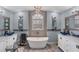 Elegant bathroom with a freestanding tub, dual sinks, and mosaic tile details at 926 Boundary Blvd, Rotonda West, FL 33947