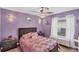 Lavender bedroom with a plush bed and serene decor at 926 Boundary Blvd, Rotonda West, FL 33947