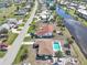 Aerial view of house and neighborhood with canal views at 93 Rotonda Cir, Rotonda West, FL 33947