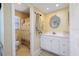 Clean bathroom with white vanity, mirror and shower/tub combo at 93 Rotonda Cir, Rotonda West, FL 33947