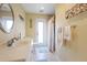 Bathroom with vanity, toilet, shower, and exterior access at 93 Rotonda Cir, Rotonda West, FL 33947