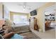Bedroom with a queen bed, dresser, and view of the kitchen at 93 Rotonda Cir, Rotonda West, FL 33947