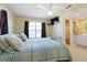 King-size bed in a well-lit bedroom with ensuite bathroom access at 93 Rotonda Cir, Rotonda West, FL 33947