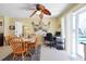 Charming dining area with wood table, chairs, and view of the pool at 93 Rotonda Cir, Rotonda West, FL 33947