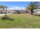 Single-story home with palm trees and well-maintained lawn at 93 Rotonda Cir, Rotonda West, FL 33947