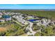 Aerial view of community with pond and houses at 9507 Carnaby Dr, Venice, FL 34293