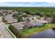 Aerial view of home with pool and lake view in a community at 9507 Carnaby Dr, Venice, FL 34293