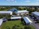 Aerial view of community complex featuring lush landscaping and parking at 9700 Fiddlers Green Cir # 117, Rotonda West, FL 33947