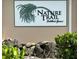 Nature Trail at Fiddler's Green community sign with lush landscaping in a tropical setting at 9700 Fiddlers Green Cir # 117, Rotonda West, FL 33947