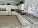 Spacious kitchen with white cabinets, neutral countertops, and modern appliances at 9700 Fiddlers Green Cir # 117, Rotonda West, FL 33947