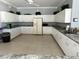 Spacious kitchen with white cabinets, neutral countertops, and modern appliances at 9700 Fiddlers Green Cir # 117, Rotonda West, FL 33947