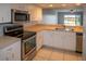 This spacious kitchen has modern appliances, a stainless sink, and is perfect for preparing meals at 9700 Fiddlers Green Cir # 117, Rotonda West, FL 33947