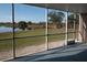 Enjoy calming lake views from the home's screened in outdoor patio area at 9700 Fiddlers Green Cir # 117, Rotonda West, FL 33947
