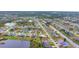 Aerial view of community with lake and houses at 1 Sportsman Ter, Rotonda West, FL 33947