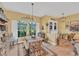 Bright dining room with farmhouse table and large windows at 1 Sportsman Ter, Rotonda West, FL 33947