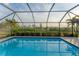 Screened pool and patio with tranquil backyard view at 1 Sportsman Ter, Rotonda West, FL 33947