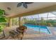 Relaxing poolside patio with seating and shade at 1 Sportsman Ter, Rotonda West, FL 33947