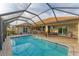 Large screened pool and patio with seating at 1 Sportsman Ter, Rotonda West, FL 33947