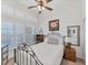 Bright bedroom with iron bed frame, window shutters and ceiling fan at 102 Natures Way # 2305, Rotonda West, FL 33947