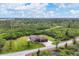 Aerial view of single-story home with large yard, showcasing the property's tranquil setting at 10451 Hatchett Cir, Port Charlotte, FL 33981