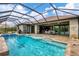 Expansive pool and spa with a covered lanai offering shade and relaxation at 10451 Hatchett Cir, Port Charlotte, FL 33981