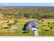 Aerial view of a beautiful property with lush landscaping and a well-maintained front yard in a quiet neighborhood at 1061 Boundary Blvd, Rotonda West, FL 33947