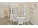 Elegant dining room featuring a chandelier, white table with seating for six, and views of the front entrance at 1061 Boundary Blvd, Rotonda West, FL 33947