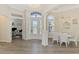 Bright dining area features a chandelier, white table and chairs, and is adjacent to the front door and office space at 1061 Boundary Blvd, Rotonda West, FL 33947