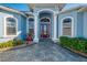 Home's detailed front entrance featuring an elegant front door, columns, and an arched entryway at 1061 Boundary Blvd, Rotonda West, FL 33947