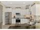 Bright kitchen with stainless steel appliances, granite countertops, subway tile backsplash, and white cabinetry at 1061 Boundary Blvd, Rotonda West, FL 33947