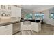 Bright kitchen features stainless steel appliances, farmhouse sink, granite counters, and white cabinetry at 1061 Boundary Blvd, Rotonda West, FL 33947