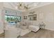 Inviting living room with white sectional, plush seating, decorative mirror, and sliding doors to the pool area at 1061 Boundary Blvd, Rotonda West, FL 33947