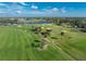 Aerial view of a section of the golf course with palm trees and sand traps at 10820 Trophy Dr, Englewood, FL 34223