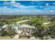 Aerial view of a golf course community with clubhouse and lush greens at 10820 Trophy Dr, Englewood, FL 34223