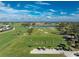 Aerial view of golf course with beautiful scenery at 10820 Trophy Dr, Englewood, FL 34223