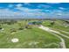 Aerial view of a golf course with fairways, greens, and sand traps at 10820 Trophy Dr, Englewood, FL 34223