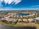 Aerial perspective of a upscale community with a lake at 10820 Trophy Dr, Englewood, FL 34223